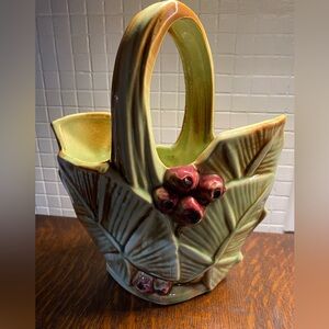 Vintage McCoy Pottery basket with palm leaf and berry design.